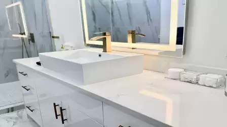 Stylish vanity with a vessel sink, illuminated mirror, and premium details in a modern bathroom.