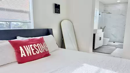Cozy bedroom with a private bathroom, modern design, and comfortable furnishings for a relaxing vacation stay.