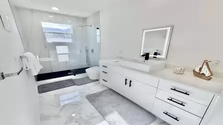 Modern bathroom with a spacious glass shower, stylish vanity, and premium finishes in an elegant design.