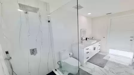 Modern bathroom with a walk-in rain shower, stylish vanity, and an elegant, bright design.