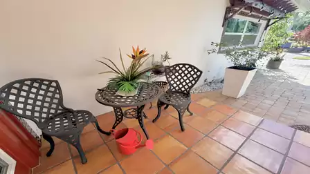 Cozy seating area at the entrance of the vacation villa in Fort Myers with Mediterranean-style tiles and tropical charm.