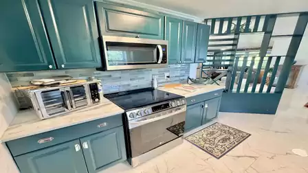 Modern kitchen in the vacation villa in Fort Myers featuring premium stainless steel appliances, ample storage and an open-concept layout.