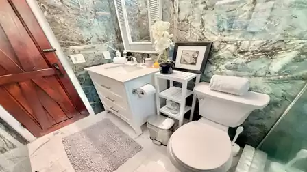 Modern bathroom with stylish vanity, natural stone look, and premium furnishings