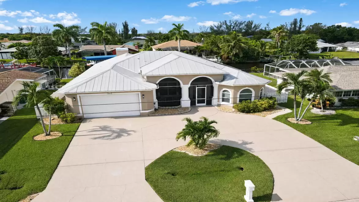 Villa Almare vacation home in Cape Coral with white metal roof and circular driveway