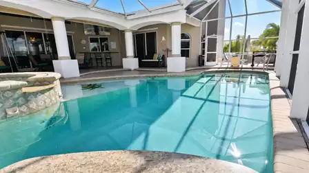 Villa Almare Cape Coral vacation rental covered lanai with screened pool, spa and seating area