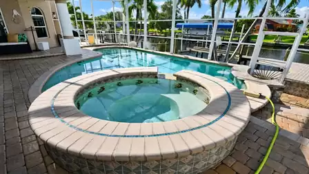 Villa Almare Cape Coral vacation rental raised circular spa, curved pool and canal boat dock