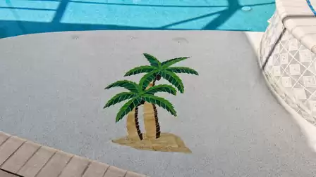 Palm tree mosaic on shallow pool ledge beside tiled raised spa wall
