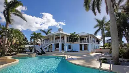 Villa Caladore vacation home in Fort Myers with curved pool, spa and palm trees