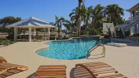 Freeform backyard pool with spa, gazebo dining area and poolside basketball hoop