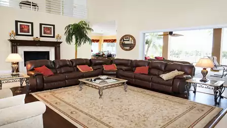 The living area shines with a cozy leather sofa
