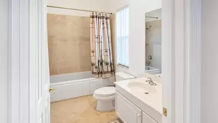 The adjacent bath features a tub