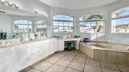 Large bathroom with double sink, bathtub and walk-in shower