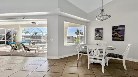The breakfast nook overlooks the pool area and the canal