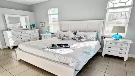 The stylish master bedroom features a King size bed