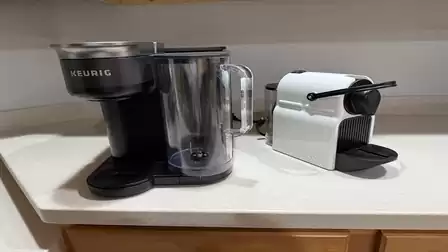 Keurig and Nespresso coffee machines side by side on a light kitchen countertop.