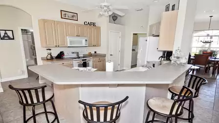 Full equipped kitchen with counter and bar chairs