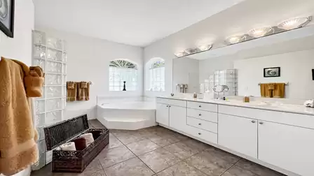 Nice decorated master bath with tub, walk in shower and double sink
