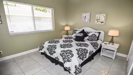 White furniture in the third guest bedroom with queen size bed