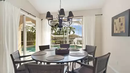 The dining area overlooks pool and sailboat canal
