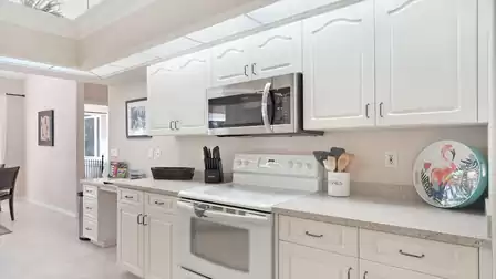 The elegant white kitchen is fully equipped