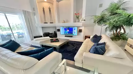 The living room invites guests to engage in conversations or enjoy a movie together