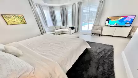 In the master bedroom, the large-screen TV offers the ultimate viewing pleasure