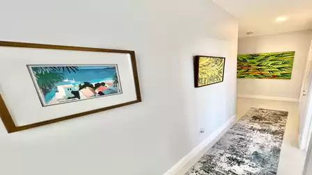 Modern paintings decorate the walls in the hallway