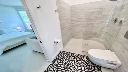 View of the large glazed shower and the fourth bedroom
