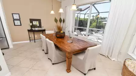 Ideal combination - rustic table and modern chairs in the light-flooded dining area