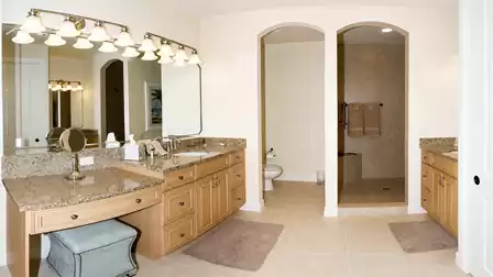 a second bathroom offers his and her sinks with a vanity and large walk in shower