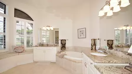The master bath offers walk-in shower, Jacuzzi tub, two separate sinks and a bench by the window