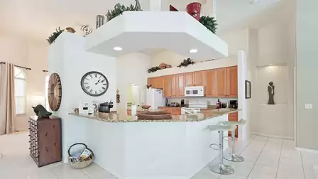 The kitchen with the long breakfast bar is fully equipped