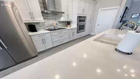 Modern white kitchen with stainless steel appliances