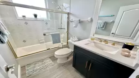 The guest bathroom has a bath/shower combination as well as a sink and WC