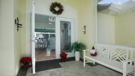 Entrance area of the villa with bench to sit on