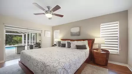 Sliders lead from the master bedroom to the pool area