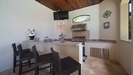 The summer kitchen on the terrace is an inviting place that makes cooking outdoors a special experience
