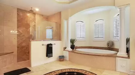 Next to the bath is a spacious walk-in shower equipped with high-quality fittings and a rain shower head