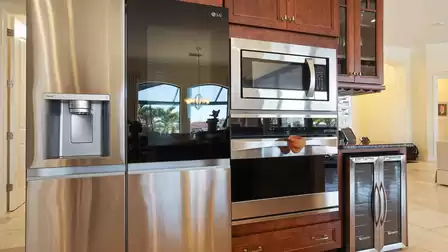 Dark wood and stainless steel appliances make for an elegant combination
