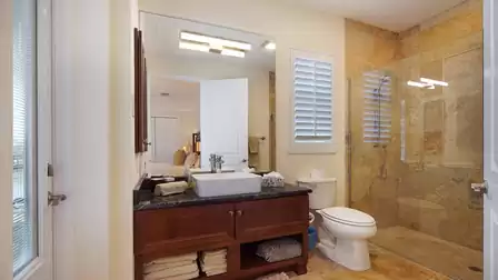 This private bathroom for bedroom 2 also serves as pool bath