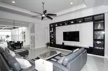 The large TV is stylishly surrounded by a shelving unit