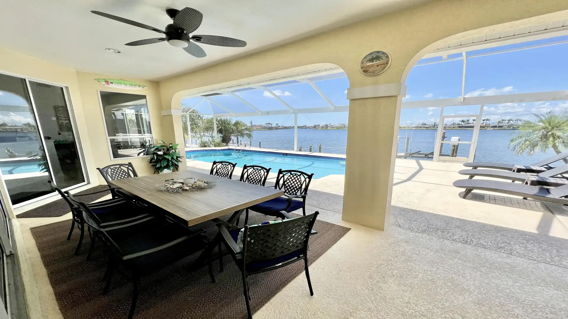 A covered terrace with a large dining table and space for eight people