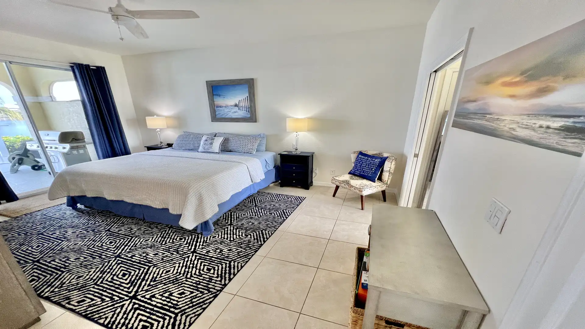 The nautical-themed master bedroom welcomes you with an oversized double bed