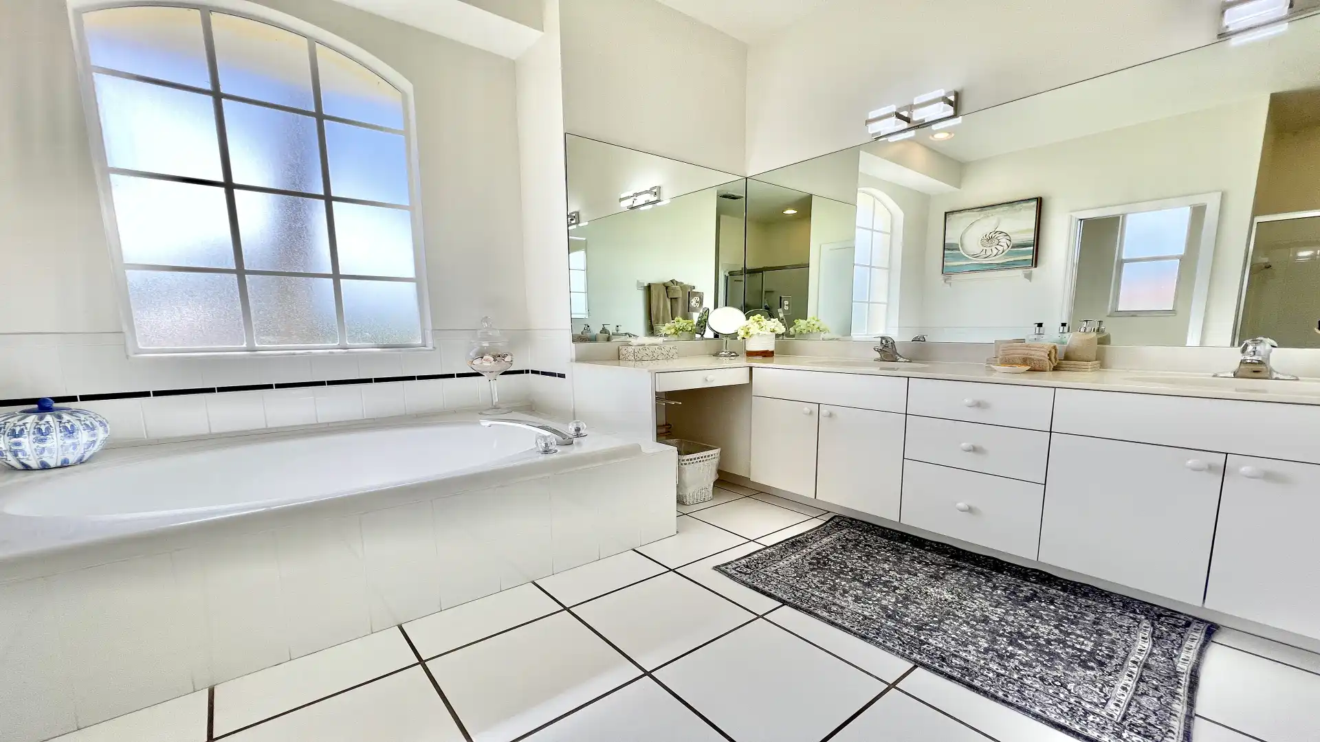 Large bathroom with bathtub and full-length mirror front