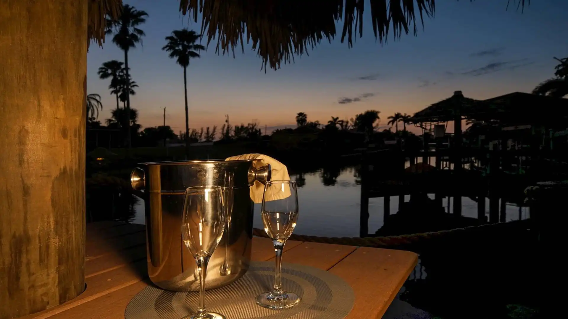 A glass of champagne on the dock at the end of the day