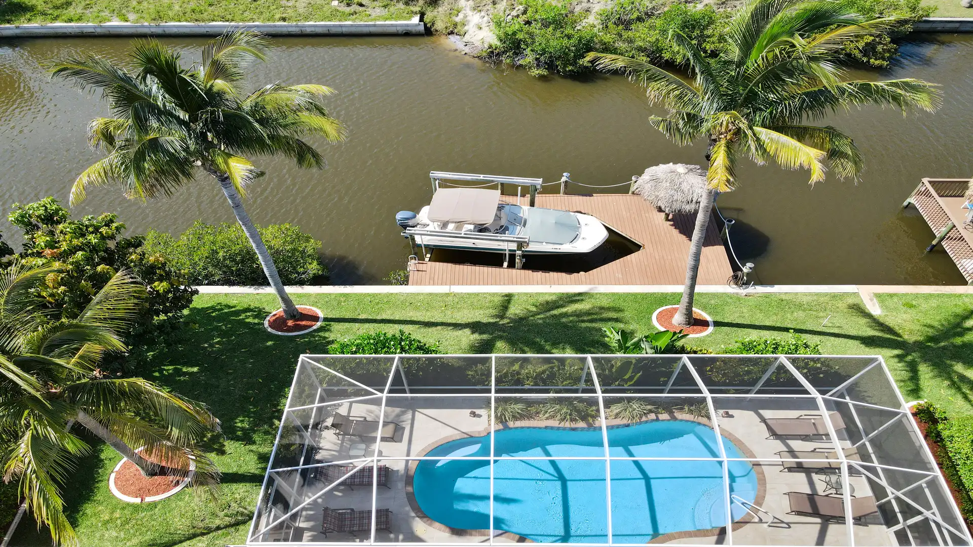 View from above of the pool and the canal with the boat dock