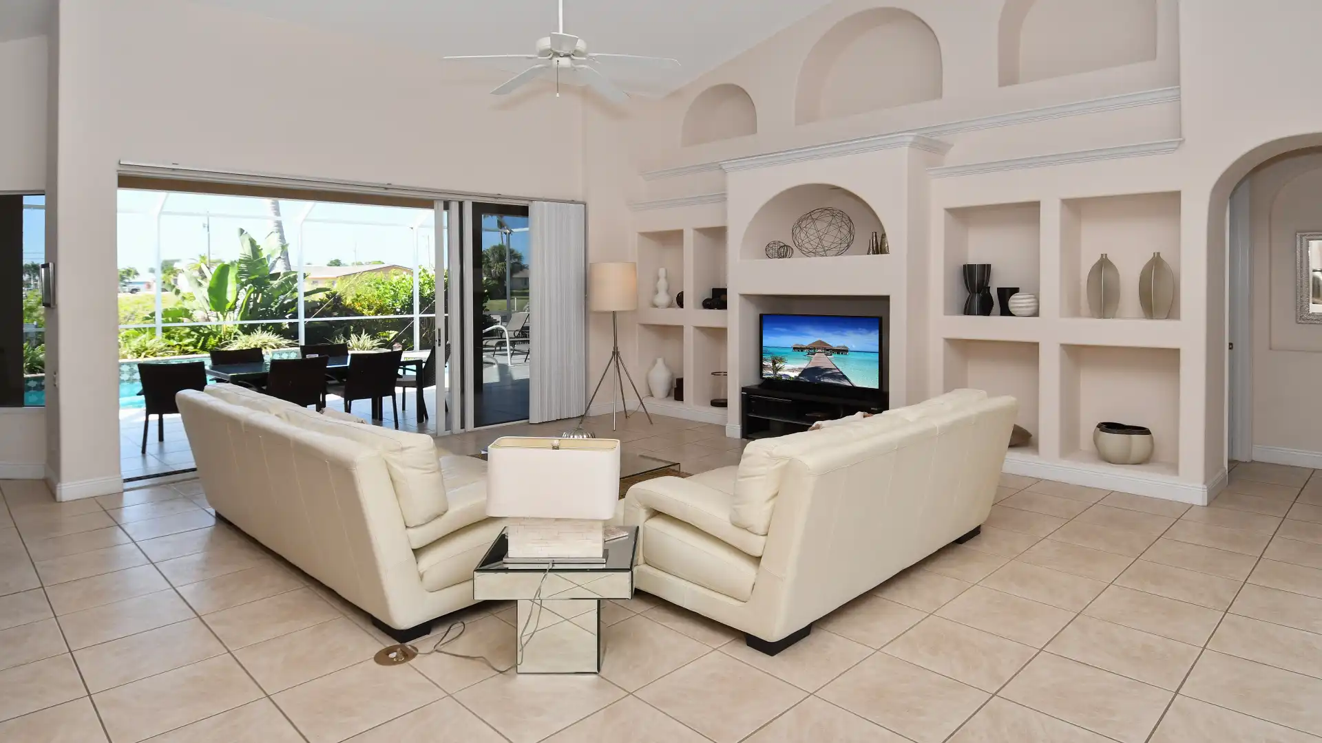 The spacious living room features a large flat screen TV