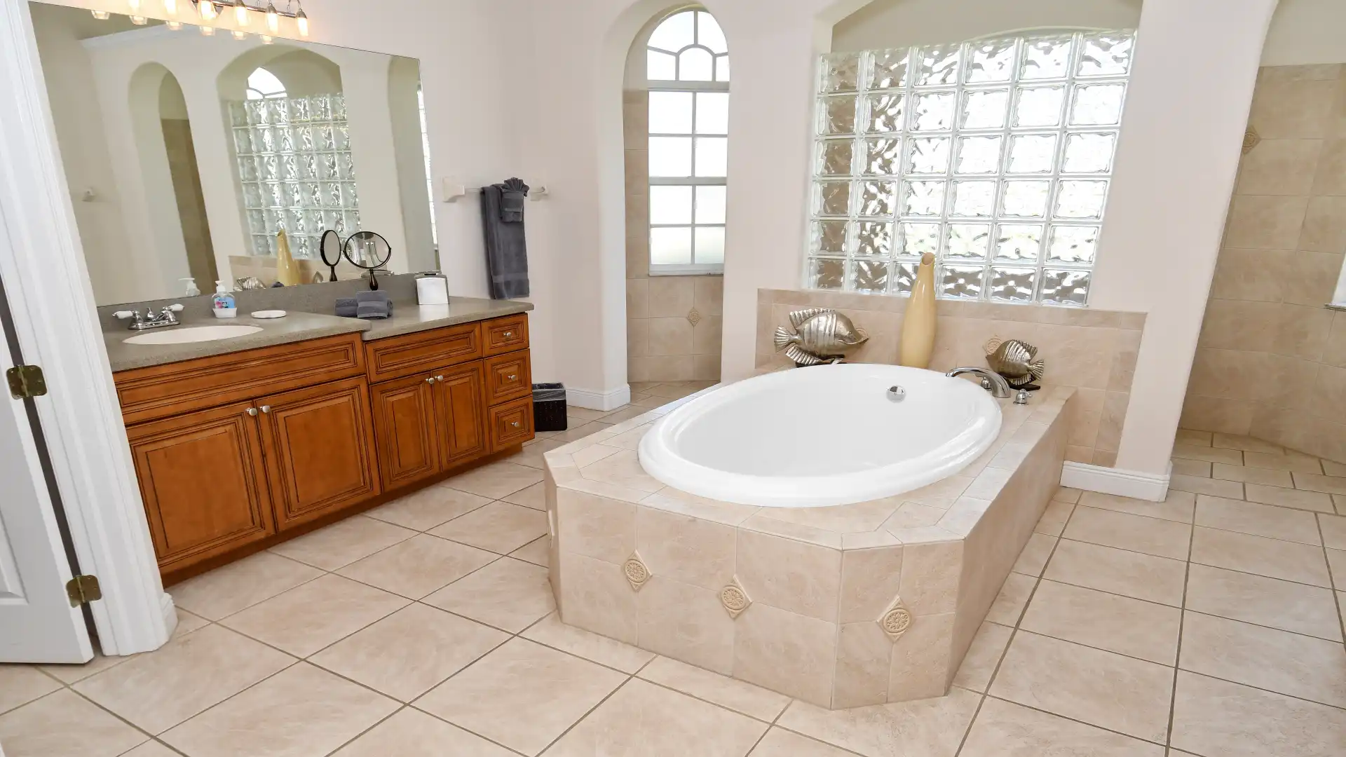 The spacious master bath offers double sink, tub and walk-through shower