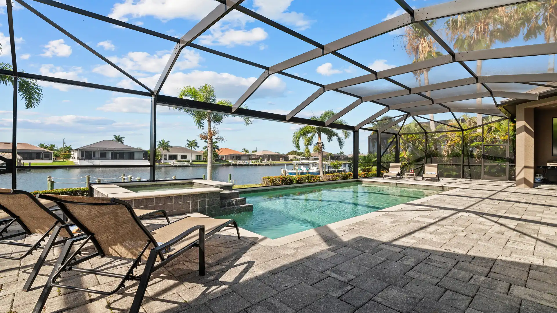 Expansive terrace with pool and canal view – perfect for relaxing vacation days.
