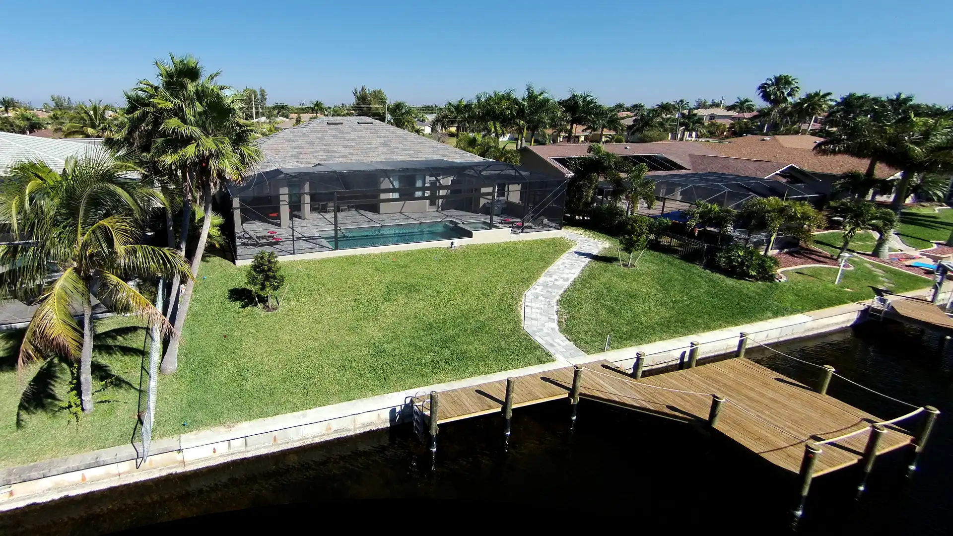 Another aerial view of the vacation home with a large property and direct access to the canal.